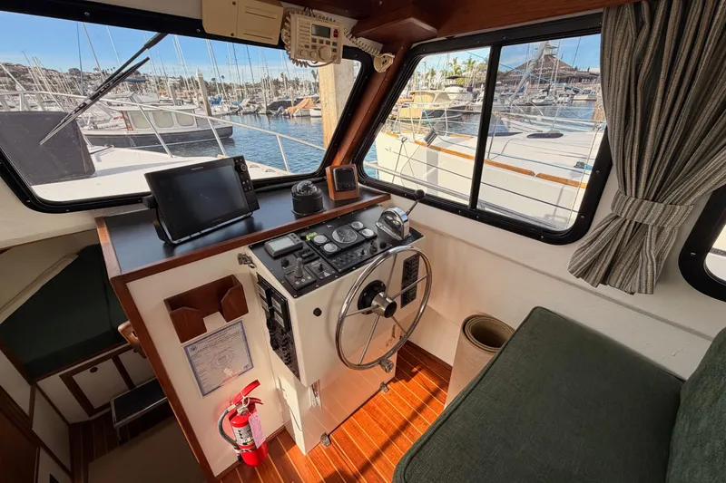 Slide: The Image of Pilothouse interior of 2002 Eastern Downeast 35 boat with navigation equipment and marina view. - 31