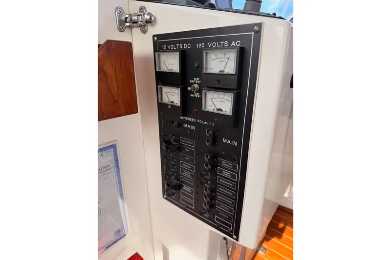 Slide: The Image of Electrical panel on a 2002 Eastern Downeast 35 boat, featuring voltage meters and switches. - 32