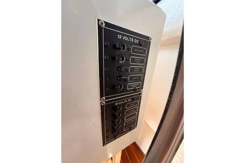 Slide: The Image of Electrical panel on a 2002 Eastern Downeast 35 boat, featuring 12-volt DC switches. - 33