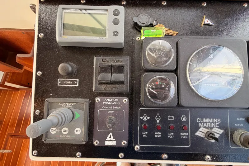 Slide: The Image of Control panel of a 2002 Eastern Downeast 35 boat with gauges and switches. - 35