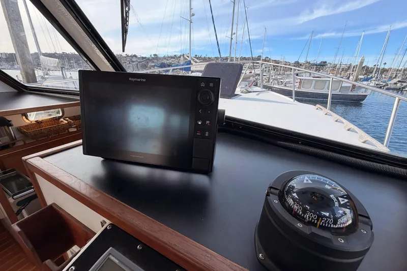 Slide: The Image of Helm of 2002 Eastern Downeast 35 with navigation equipment and compass, overlooking marina. - 39