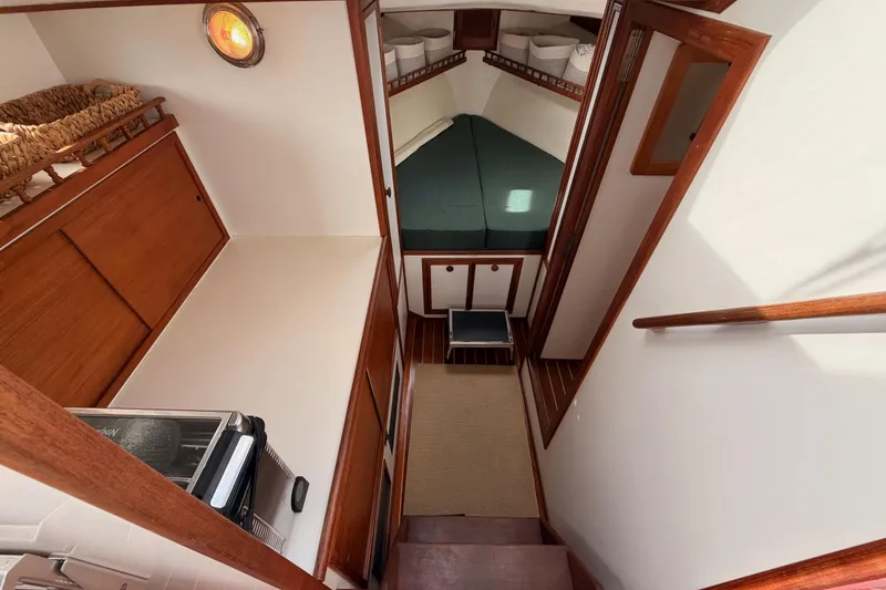 Slide: The Image of Interior of 2002 Eastern Downeast 35 boat, featuring cozy cabin and wooden finishes. - 41