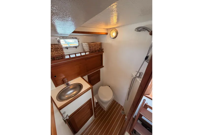 Slide: The Image of Compact bathroom in 2002 Eastern Downeast 35 boat with sink, toilet, and shower. - 44