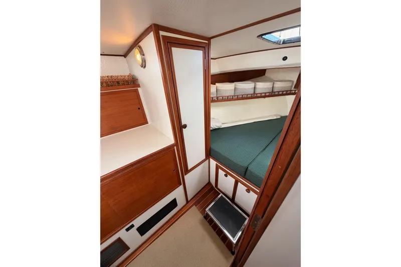 Slide: The Image of 2002 Eastern Downeast 35 cabin interior with wooden finish and cozy sleeping area. - 47