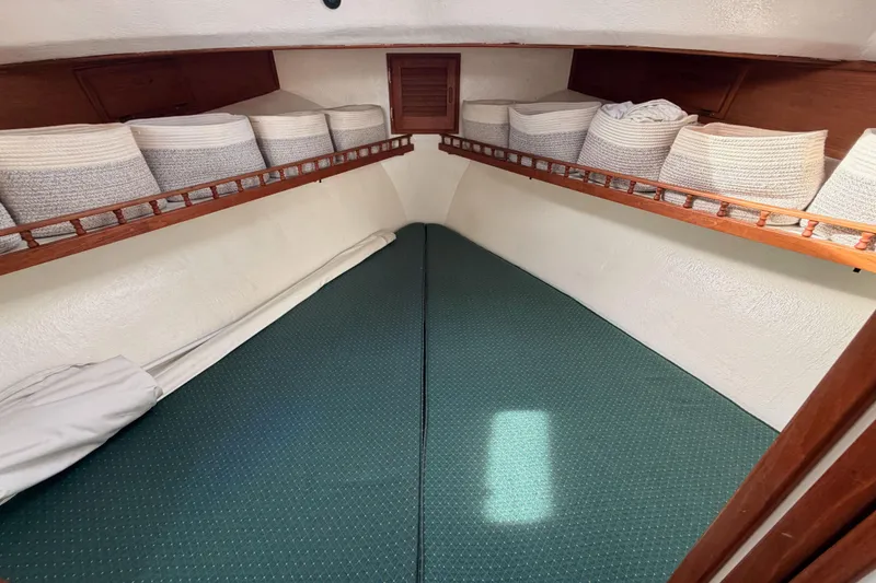 Slide: The Image of Cozy cabin interior of 2002 Eastern Downeast 35 boat with green bedding and storage baskets. - 53