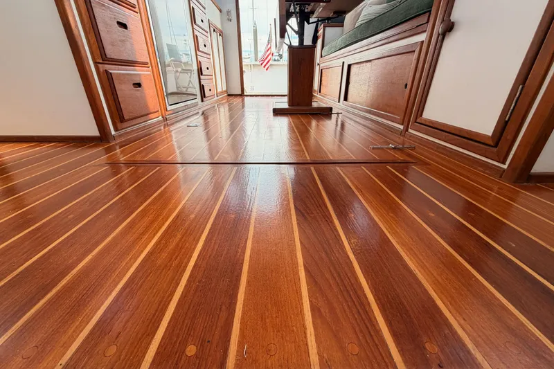 Slide: The Image of Polished wooden interior of 2002 Eastern Downeast 35 boat, featuring elegant cabinetry and flooring. - 58