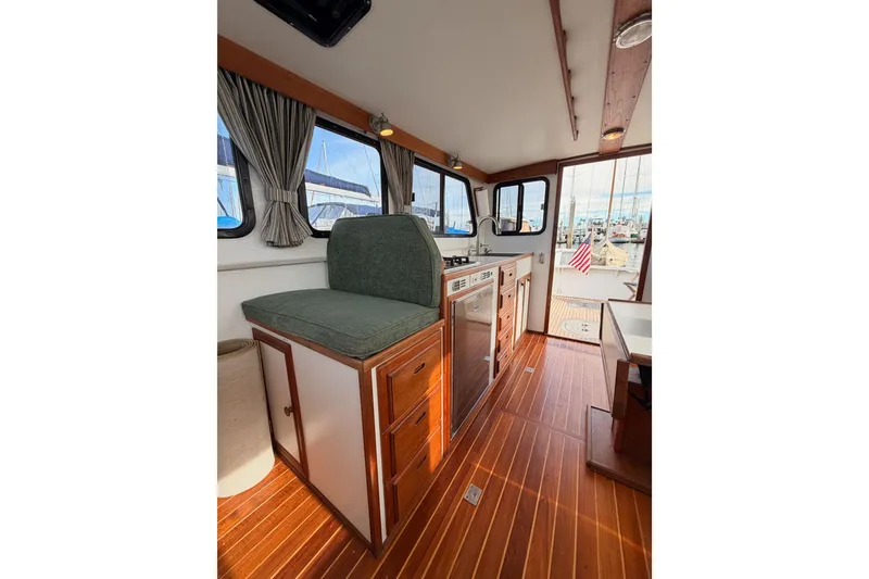 Slide: The Image of Interior of 2002 Eastern Downeast 35 boat with wood flooring and seating area. - 60