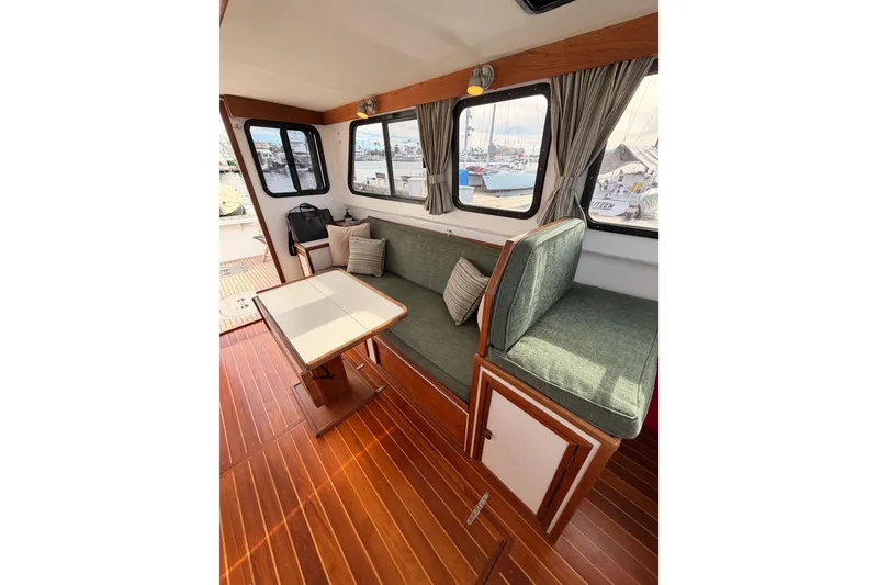 Slide: The Image of Interior of 2002 Eastern Downeast 35 boat with wooden flooring and green seating. - 61