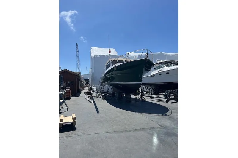 Slide: The Image of 2002 Eastern Downeast 35 boat on dry dock under clear blue sky. - 66