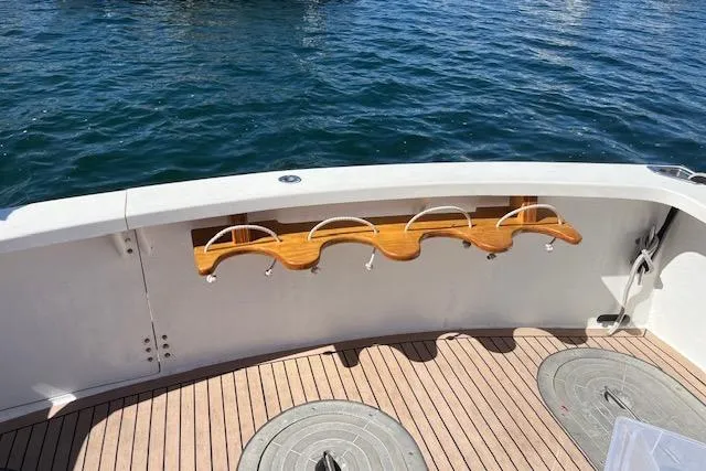 Slide: The Image of 2002 Eastern Downeast 35 boat deck with rod holders, wooden flooring, and ocean view. - 68