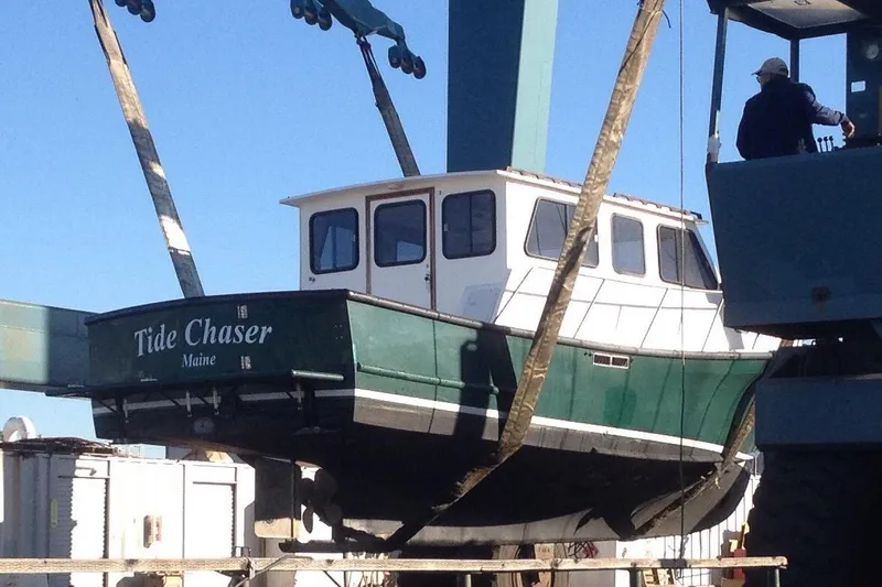 Slide: The Image of Eastern Downeast 35 boat, "Tide Chaser," being lifted, Maine, 2002 model. - 70