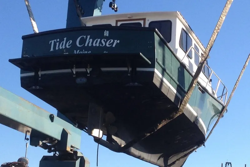 Slide: The Image of 2002 Eastern Downeast 35 boat "Tide Chaser" being lifted by crane. - 72