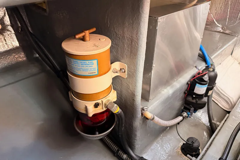 Slide: The Image of Engine compartment of a 2002 Eastern Downeast 35, featuring a diesel fuel water separator. - 75