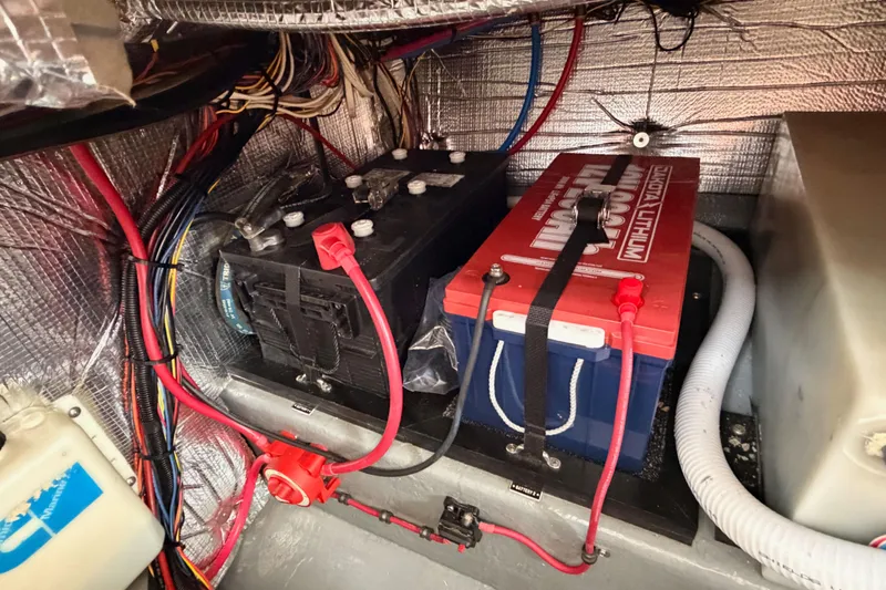 Slide: The Image of Battery compartment of a 2002 Eastern Downeast 35 boat with wiring and insulation. - 77