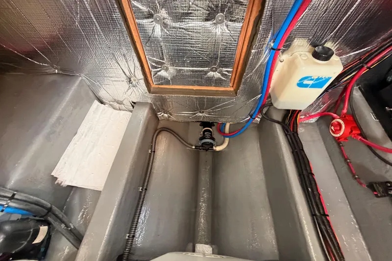 Slide: The Image of Engine compartment of a 2002 Eastern Downeast 35 boat, featuring wiring and insulation. - 78