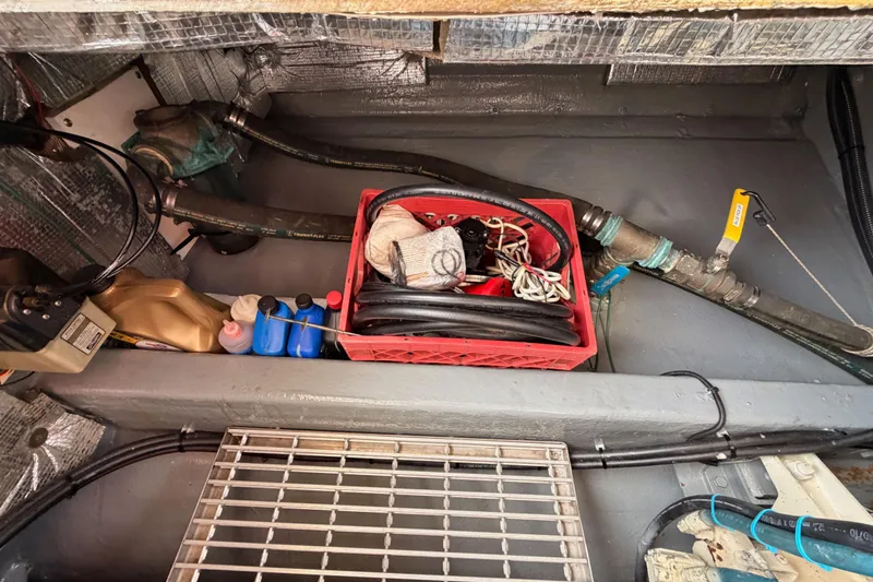 Slide: The Image of Engine compartment of 2002 Eastern Downeast 35 with tools and maintenance supplies. - 81