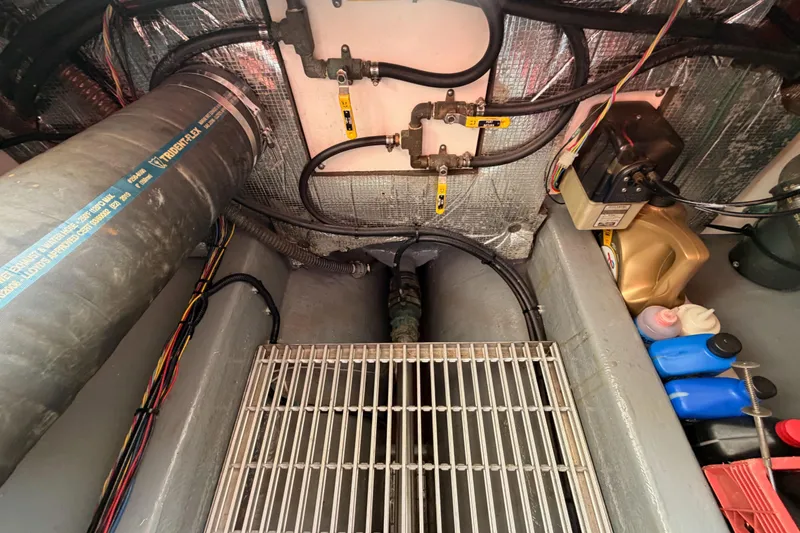 Slide: The Image of Engine compartment of a 2002 Eastern Downeast 35 boat, showing pipes and wiring. - 82