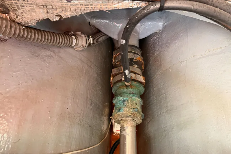 Slide: The Image of Engine compartment of a 2002 Eastern Downeast 35 boat, showing mechanical components and hoses. - 83