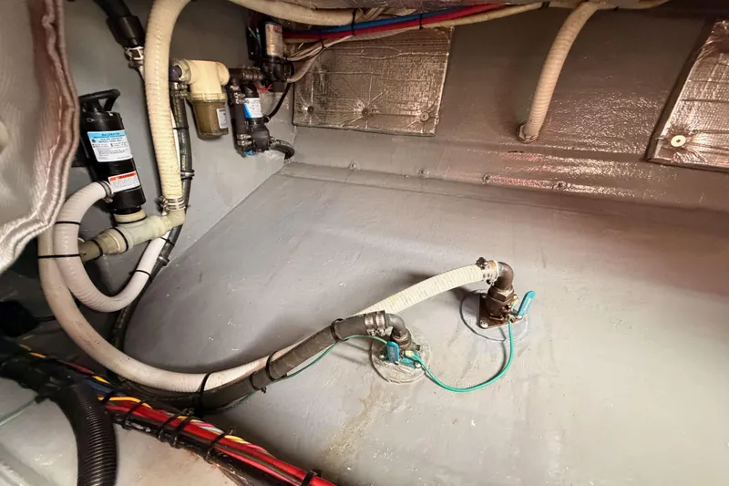 Slide: The Image of Engine compartment of a 2002 Eastern Downeast 35 boat, showing hoses and fittings. - 85