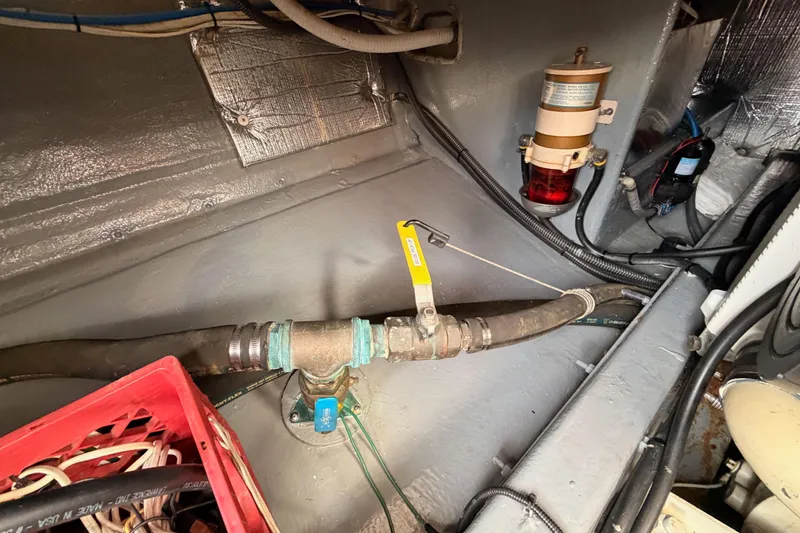 Slide: The Image of Engine compartment of a 2002 Eastern Downeast 35 boat, showing hoses and a fuel filter. - 86