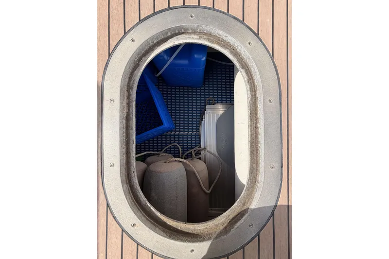 Slide: The Image of Oval hatch on 2002 Eastern Downeast 35 boat deck, revealing storage area. - 87