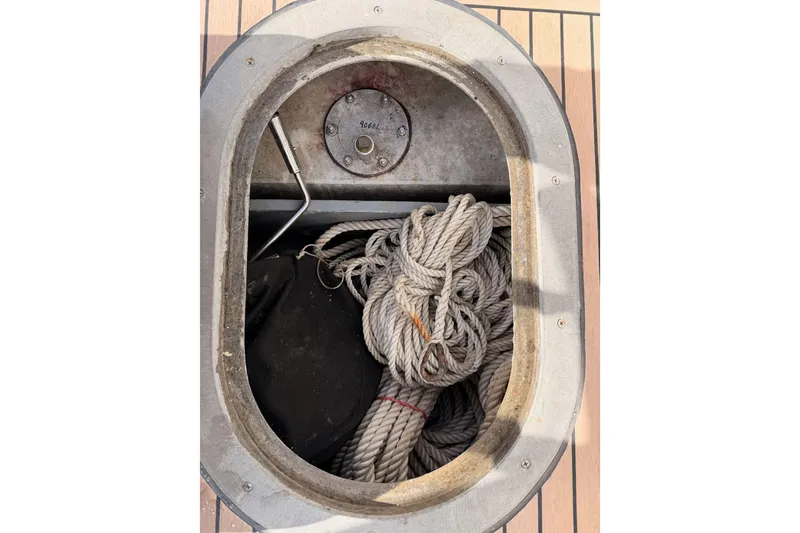Slide: The Image of Open hatch on 2002 Eastern Downeast 35 boat with coiled rope inside. - 88