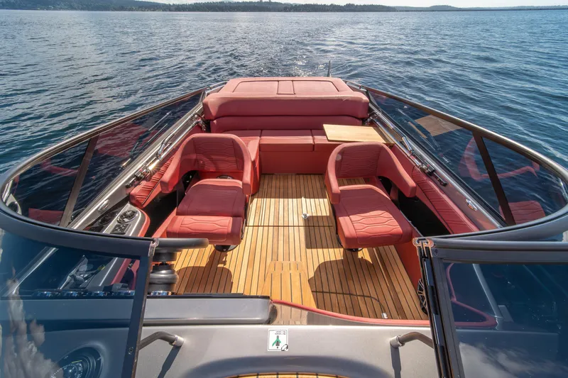 Slide: The Image of 2026 Cranchi E26 Classic boat interior with red seating and wooden deck on open water. - 11