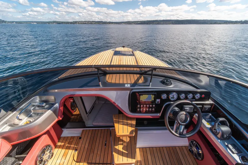 Slide: The Image of 2026 Cranchi E26 Classic boat interior with wooden deck and modern controls on open water. - 12