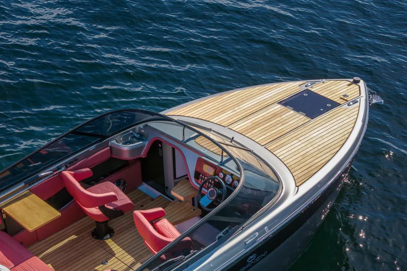 Slide: The Image of 2026 Cranchi E26 Classic boat with sleek design and luxurious red interior on water. - 13