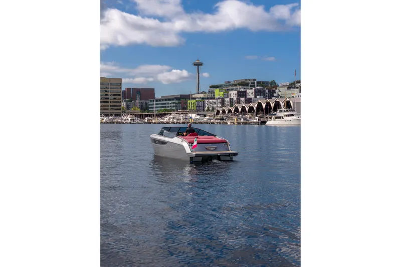 Slide: The Image of 2026 Cranchi E26 Classic boat cruising in urban waterfront with city skyline. - 14