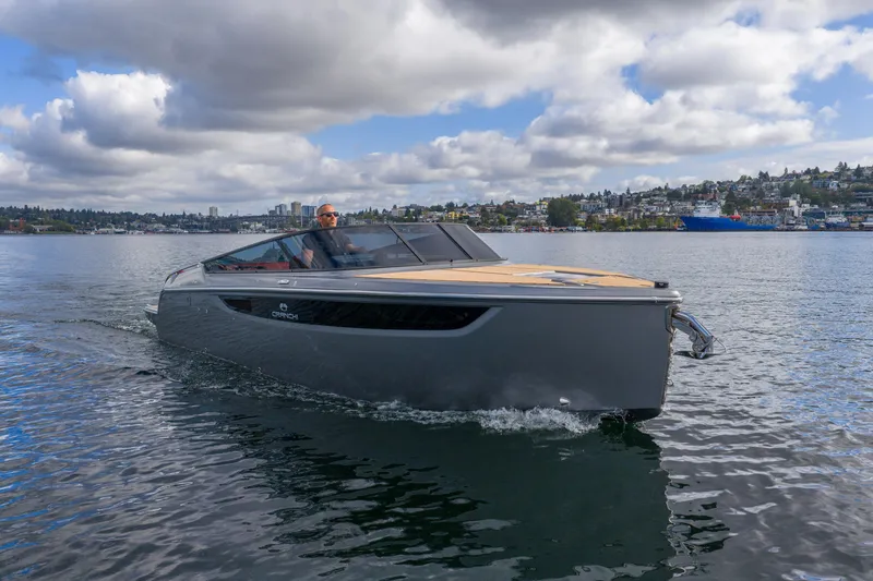Slide: The Image of 2026 Cranchi E26 Classic boat cruising on a calm lake under a cloudy sky. - 15