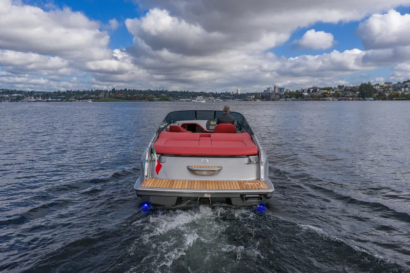 Slide: The Image of 2026 Cranchi E26 Classic boat cruising on a lake under cloudy skies. - 18