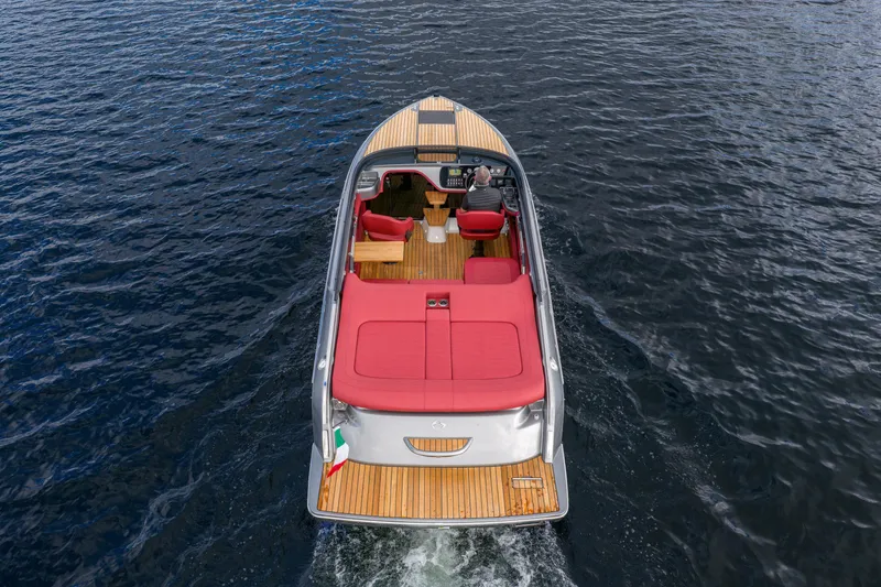 Slide: The Image of 2026 Cranchi E26 Classic boat with red seating, cruising on open water. - 19