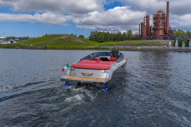 Slide: The Image of 2026 Cranchi E26 Classic boat cruising near industrial park under cloudy sky. - 28