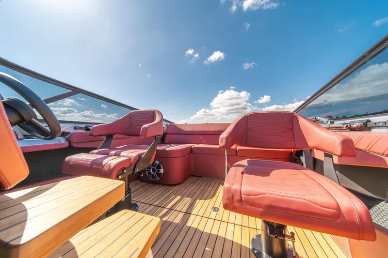 Slide: The Image of Luxurious interior of 2026 Cranchi E26 Classic boat with red leather seats and wooden flooring. - 31