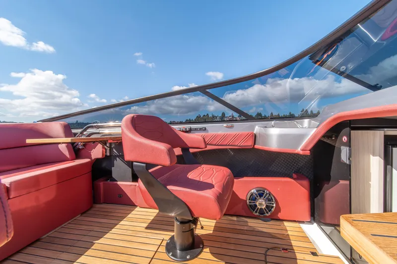 Slide: The Image of Luxurious interior of 2026 Cranchi E26 Classic boat with red seating and wooden flooring. - 32