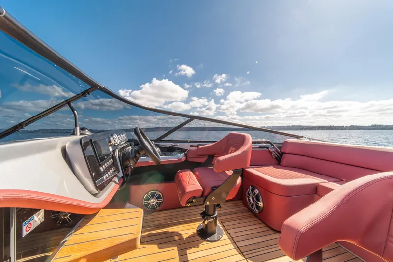 Slide: The Image of 2026 Cranchi E26 Classic boat interior with red seating and wooden flooring. - 34