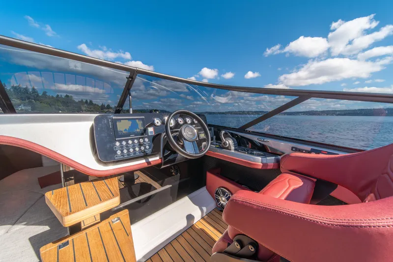 Slide: The Image of 2026 Cranchi E26 Classic boat interior with red seats and modern dashboard on a sunny day. - 38