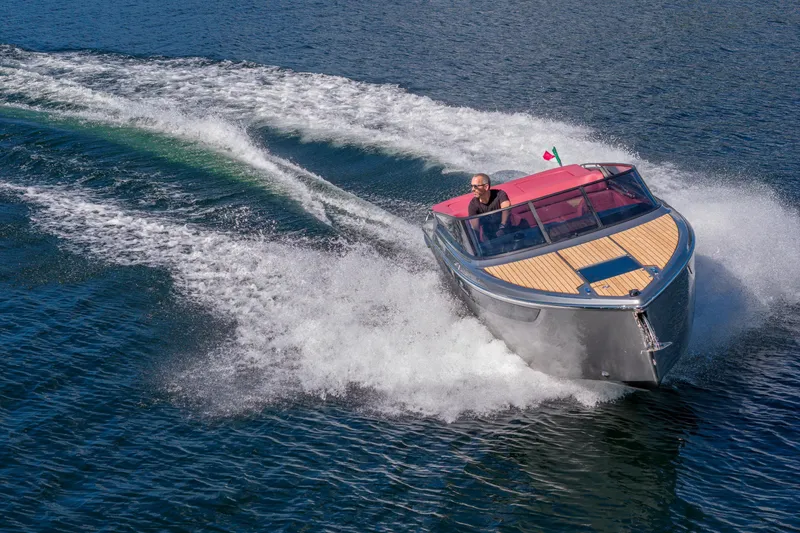 Slide: The Image of 2026 Cranchi E26 Classic speedboat cruising on open water, showcasing sleek design. - 4