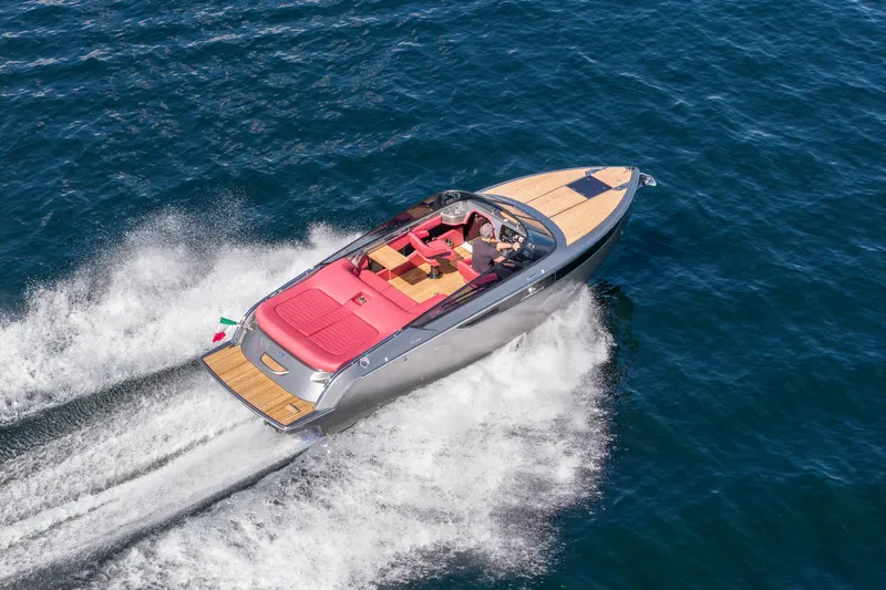 Slide: The Image of 2026 Cranchi E26 Classic speedboat cruising on open water, featuring sleek design and red seating. - 41