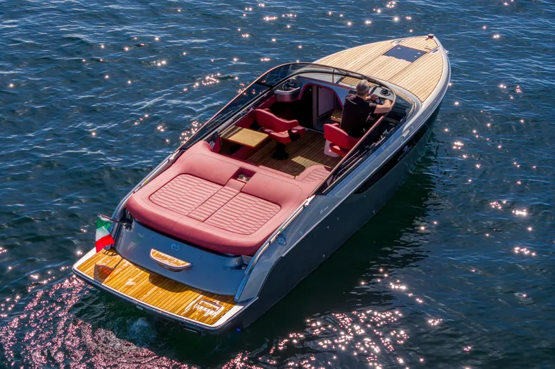 Slide: The Image of 2026 Cranchi E26 Classic luxury boat on sparkling water, featuring elegant design and Italian flag. - 42