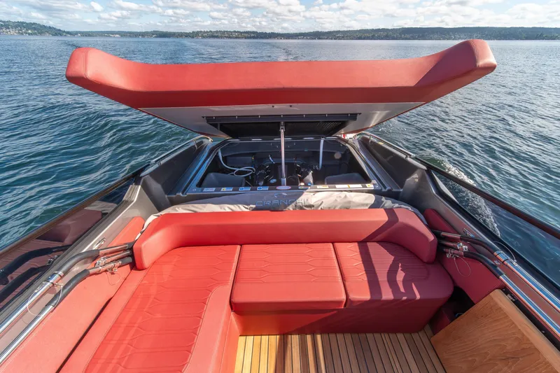Slide: The Image of 2026 Cranchi E26 Classic boat with red seating and open engine compartment on water. - 45