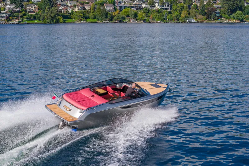 Slide: The Image of 2026 Cranchi E26 Classic cruising on a scenic lake with vibrant surroundings. - 5