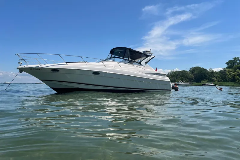 The Image of 2006 Regal Commodore 3560 IO yacht on calm water under clear blue sky. - 0