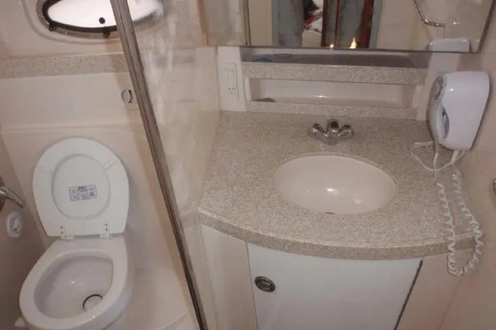 Slide: The Image of Bathroom interior of 2006 Regal Commodore 3560 IO yacht with sink and toilet. - 13