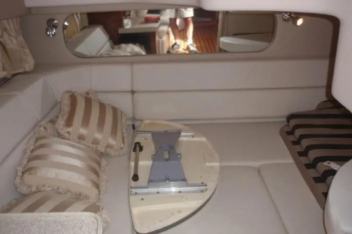 Slide: The Image of 2006 Regal Commodore 3560 IO interior with beige seating and striped pillows. - 14