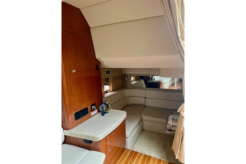 Slide: The Image of Interior of 2006 Regal Commodore 3560 IO yacht with cozy seating and wooden accents. - 19