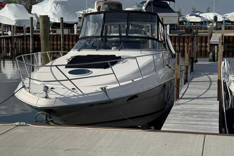 Slide: The Image of 2006 Regal Commodore 3560 IO boat docked at marina, surrounded by other vessels. - 2