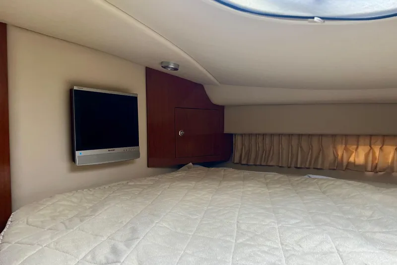 Slide: The Image of Interior cabin of 2006 Regal Commodore 3560 IO with bed and wall-mounted TV. - 26