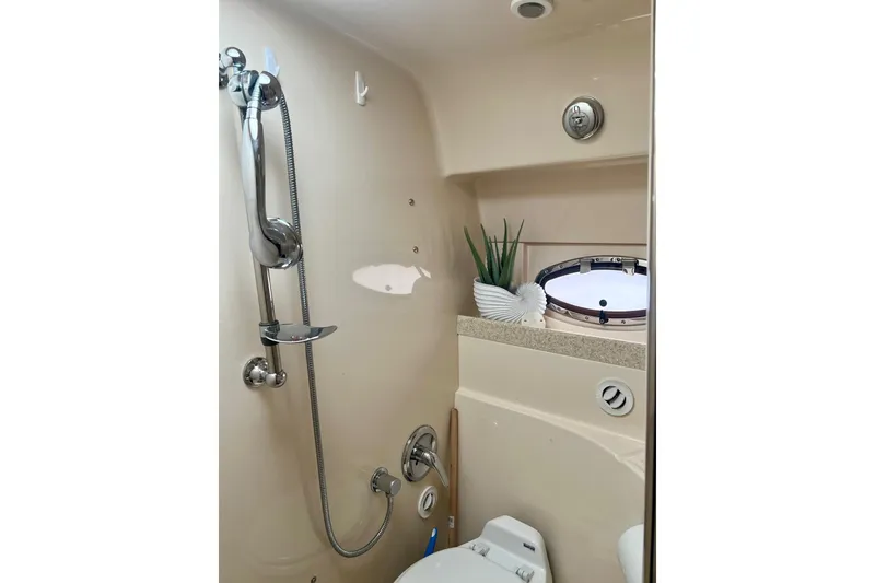 Slide: The Image of 2006 Regal Commodore 3560 IO bathroom with shower, porthole, and decorative plants. - 27